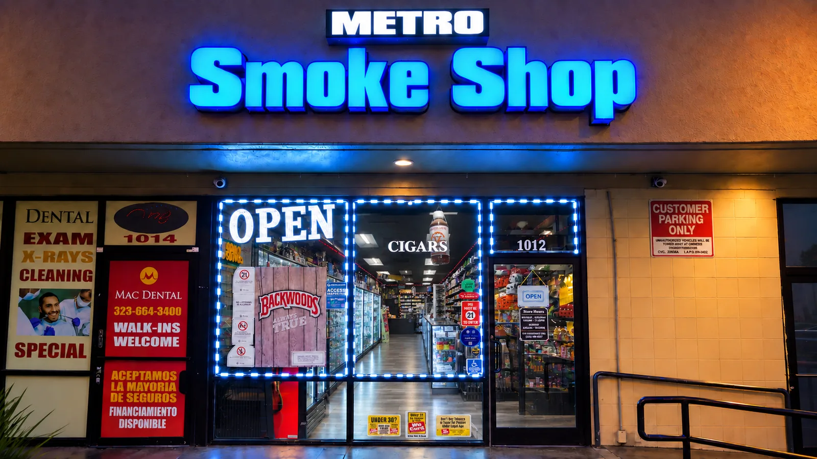 The Metro Smoke Shop storefront at 1012 N Vermont Ave, blue sign lit at dusk